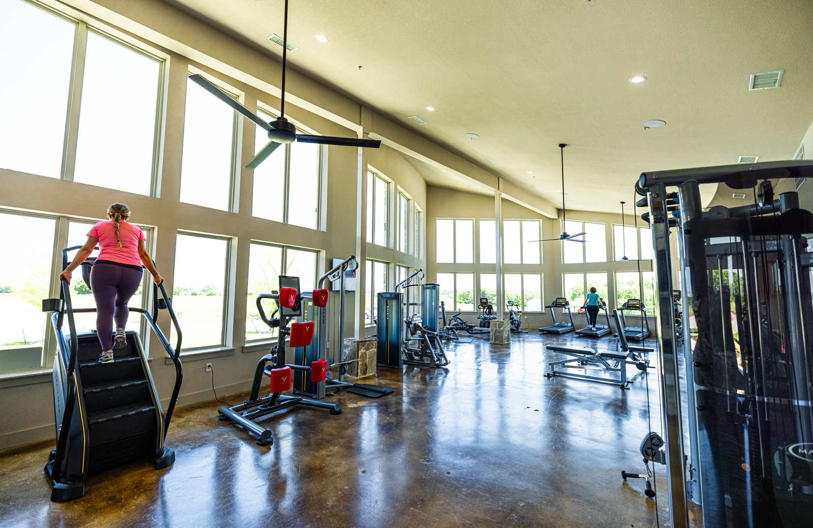 fitness center with gym equipment and windows