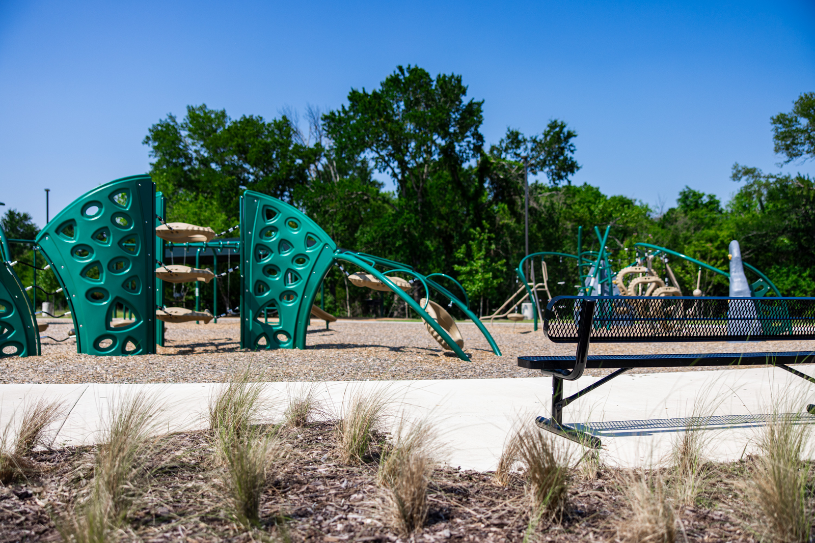 playground with jungle gym and bench