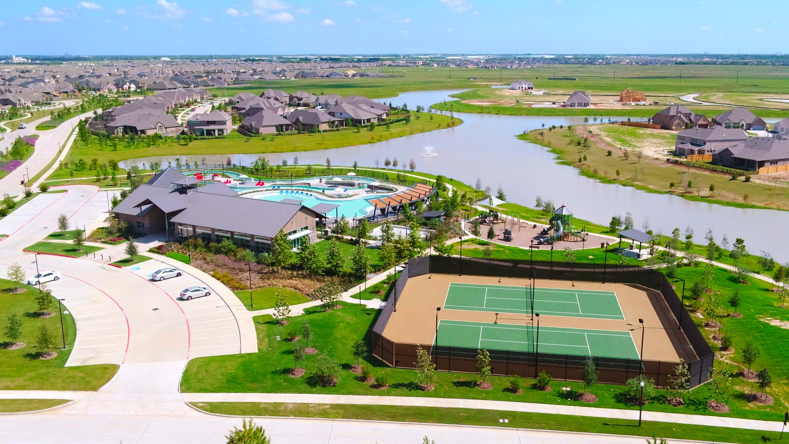 ariel view of tennis courts and community pool 