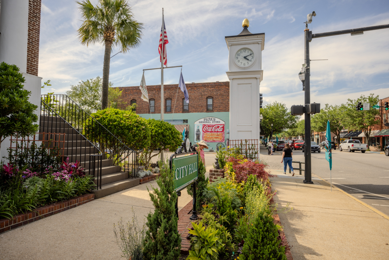 Downtown historic Conway with sidewalks, greenery and people walking.  