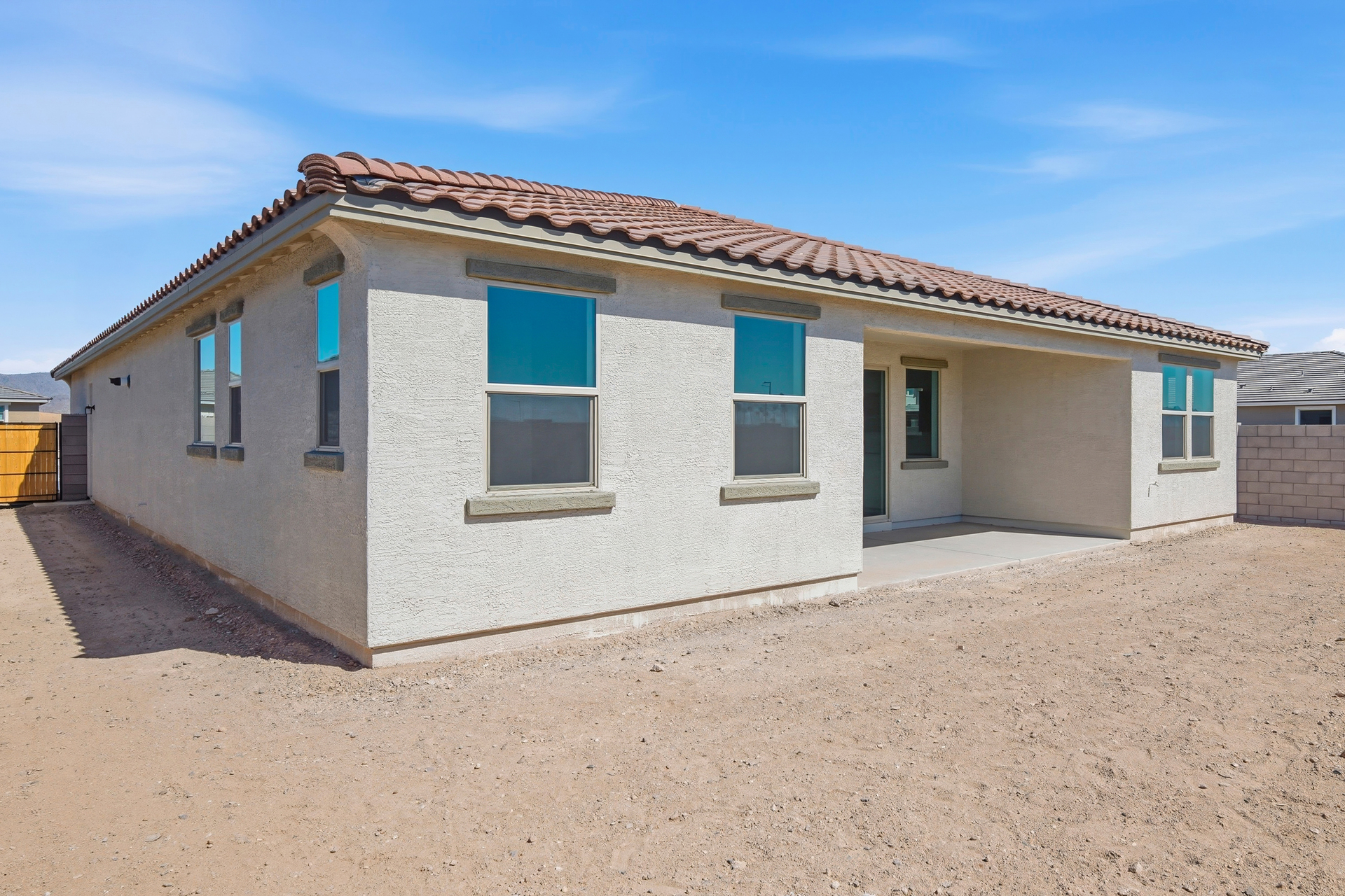 spacious backyard with views of the covered patio 