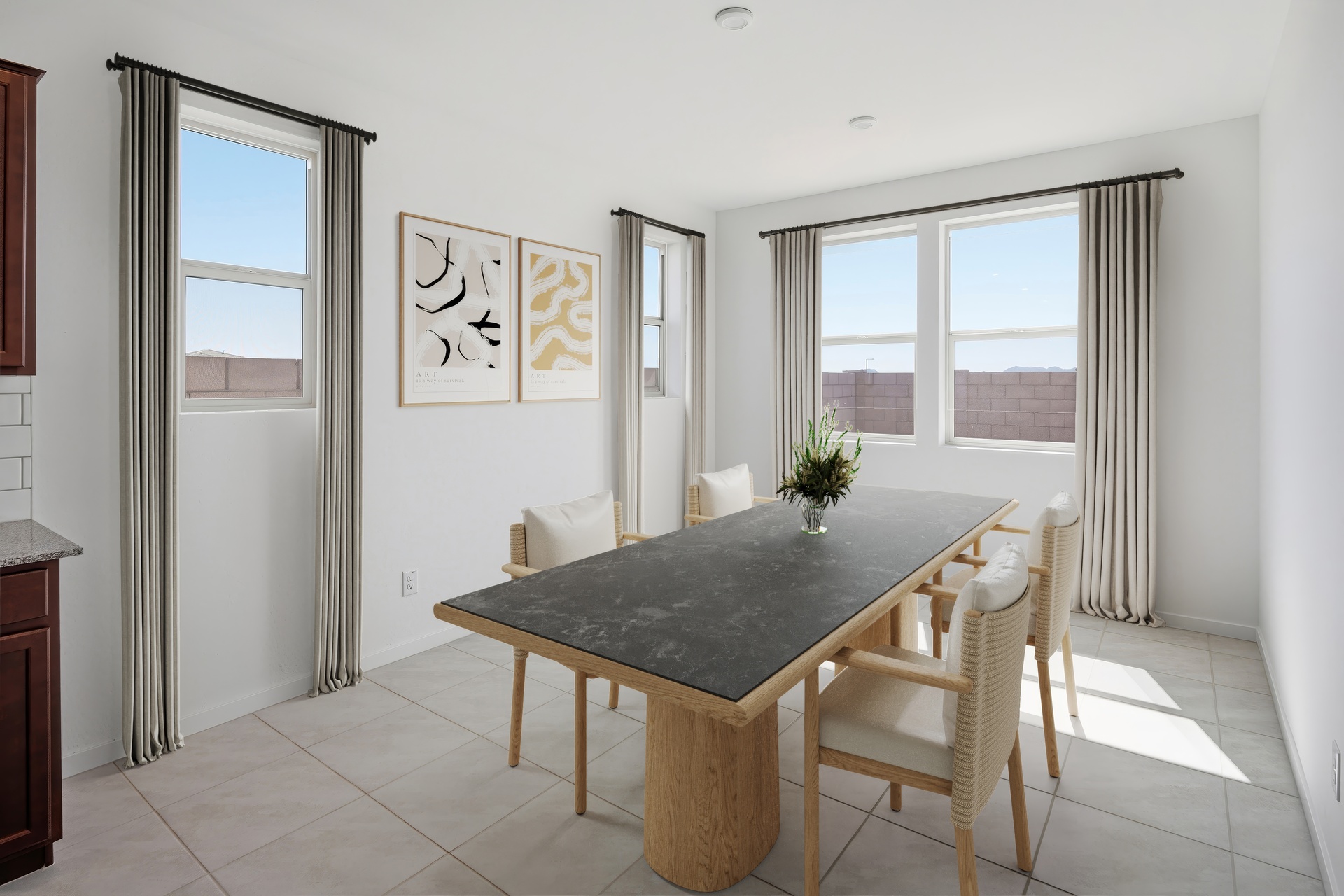 open-concept space with a large wooden dining table and white dining chairs