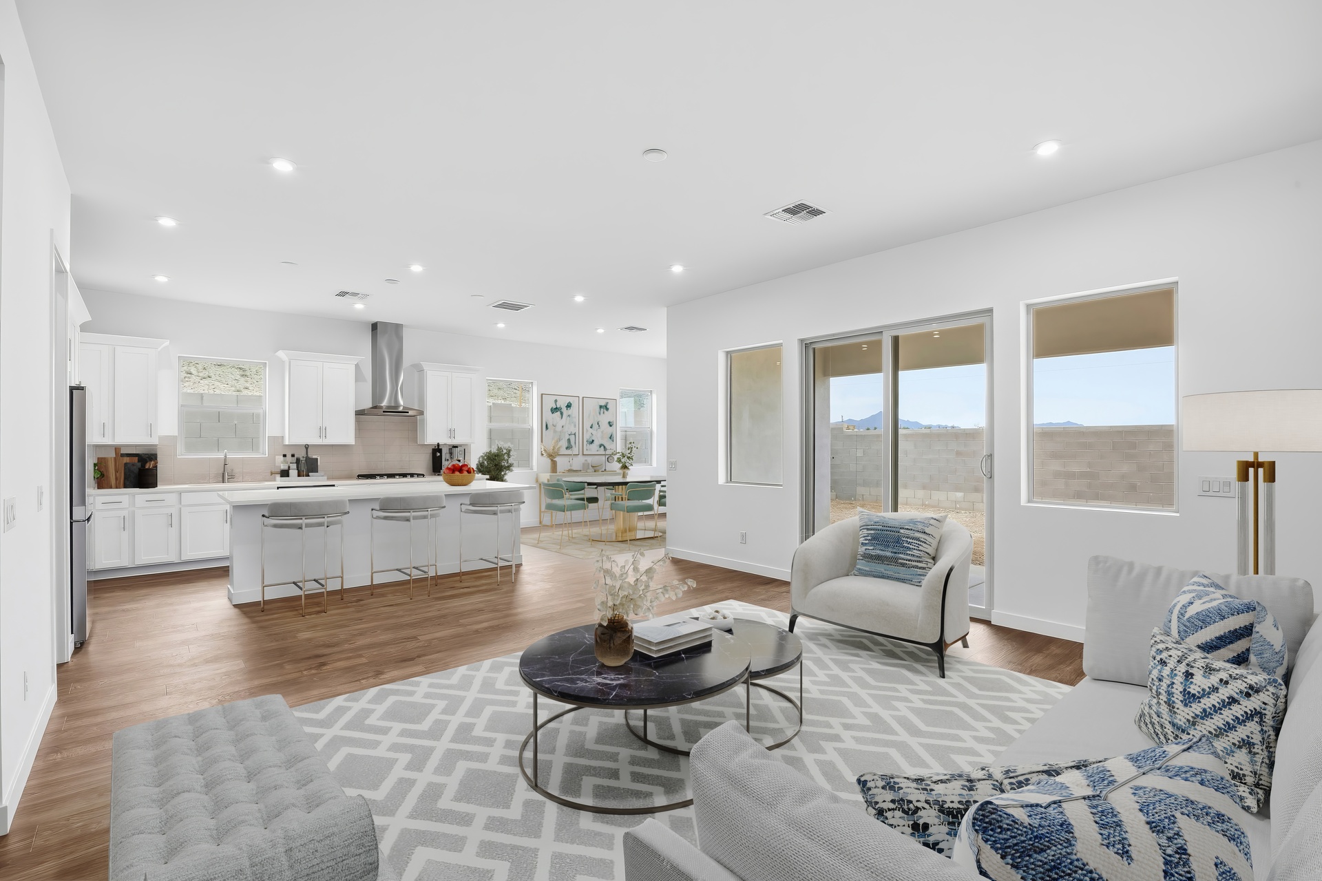 open-concept space with large white couch, marble coffee table, and wood-like flooring