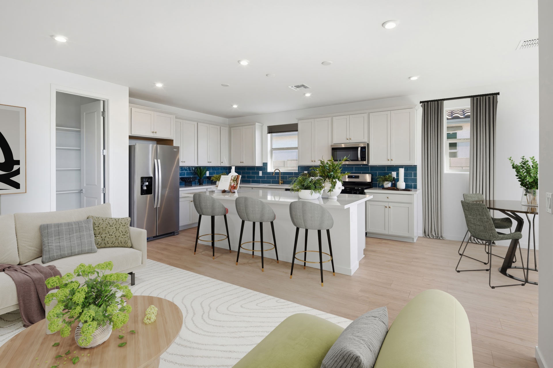 open-concept space with white rug, wooden coffee table, white couch, and light green couch