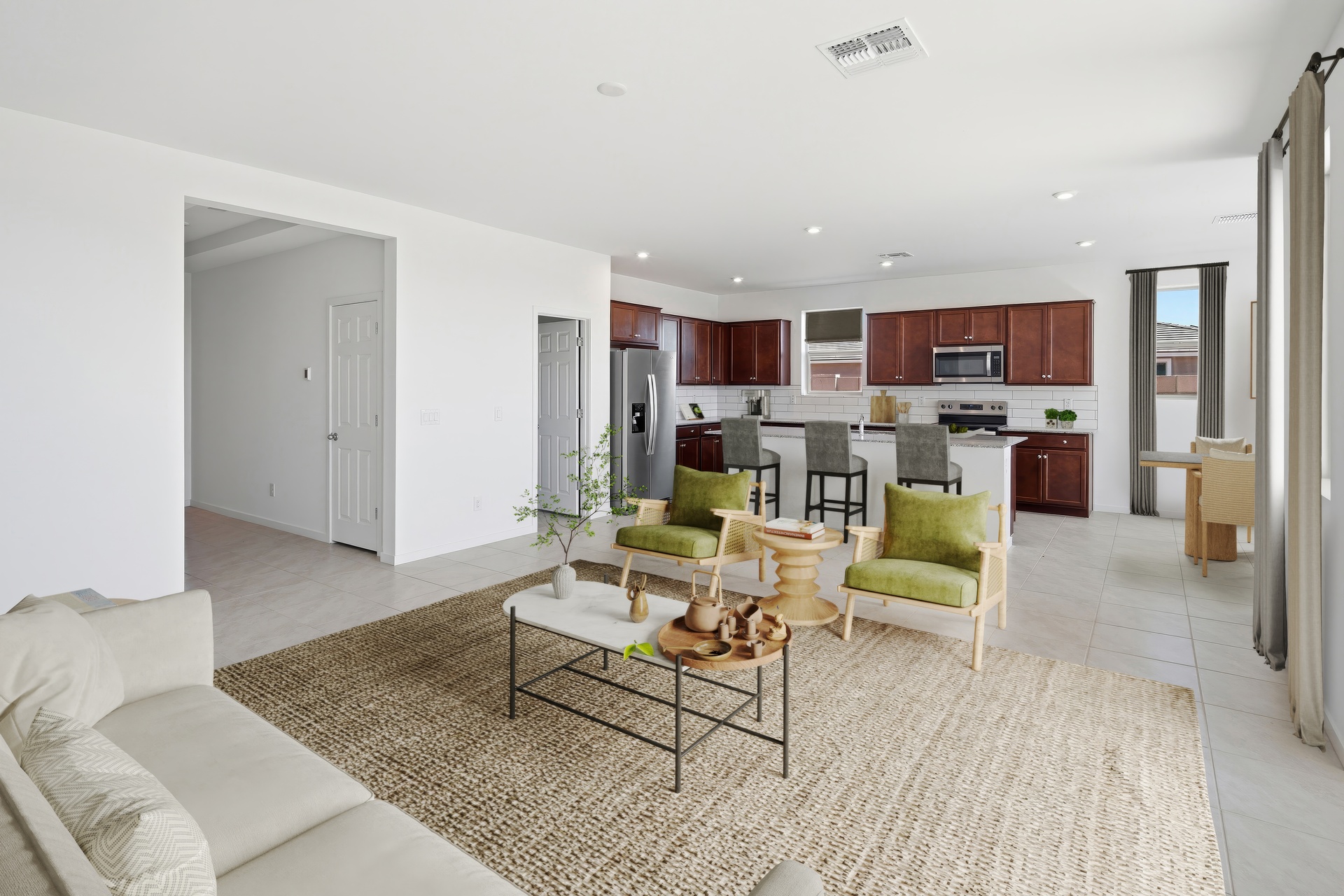 open-concept space with a large white couch, light brown rug, and a marble coffee table