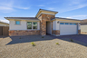 single-story single-family home with desert landscaping and paver driveway