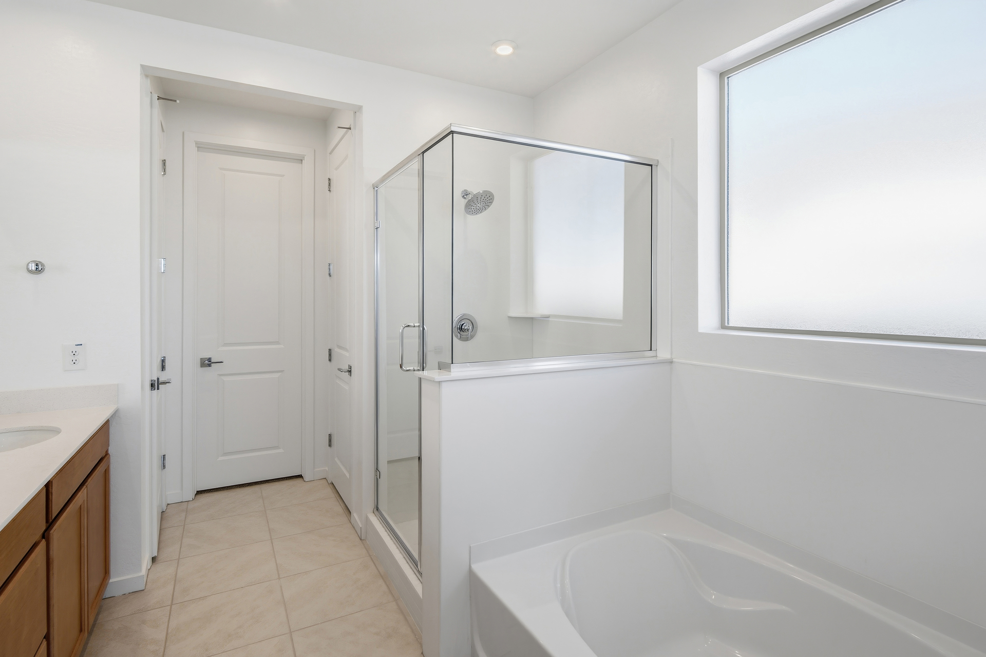 bathroom with a walk-in shower and soaking tub