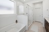 spacious bathroom with a walk-in shower and a soaking tub