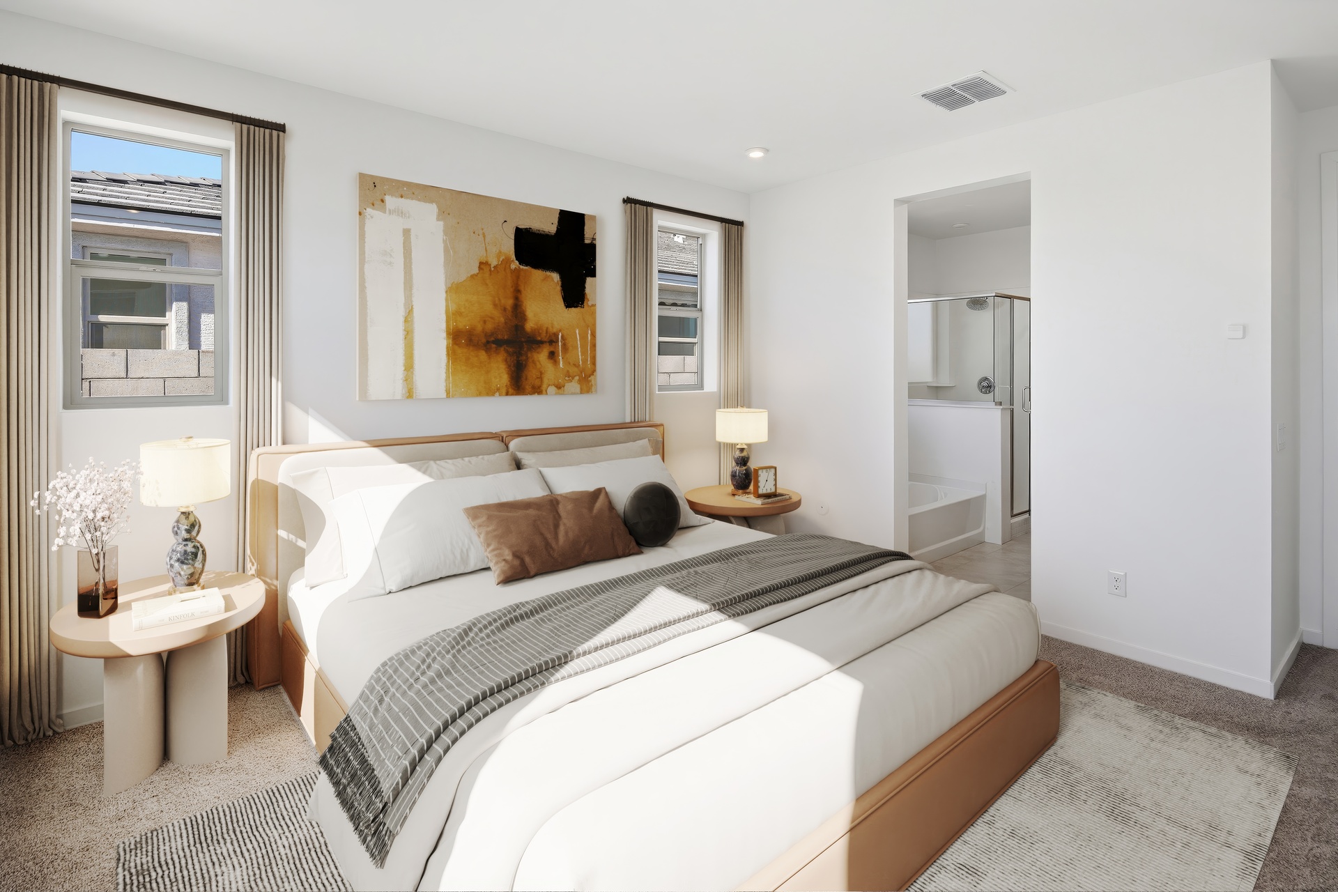 spacious bedroom with a king-sized bed, a white rug, and wooden nightstands