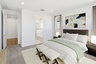 spacious room with a large couch, white grid pattern covers, and a white bed bench