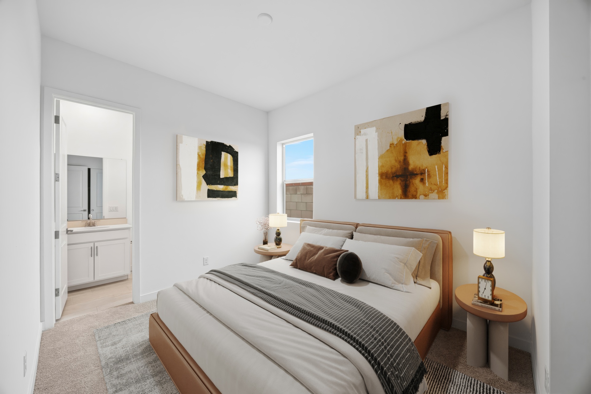 bedroom with a brown leather bedframe, white mattress covers, and brown nightstands