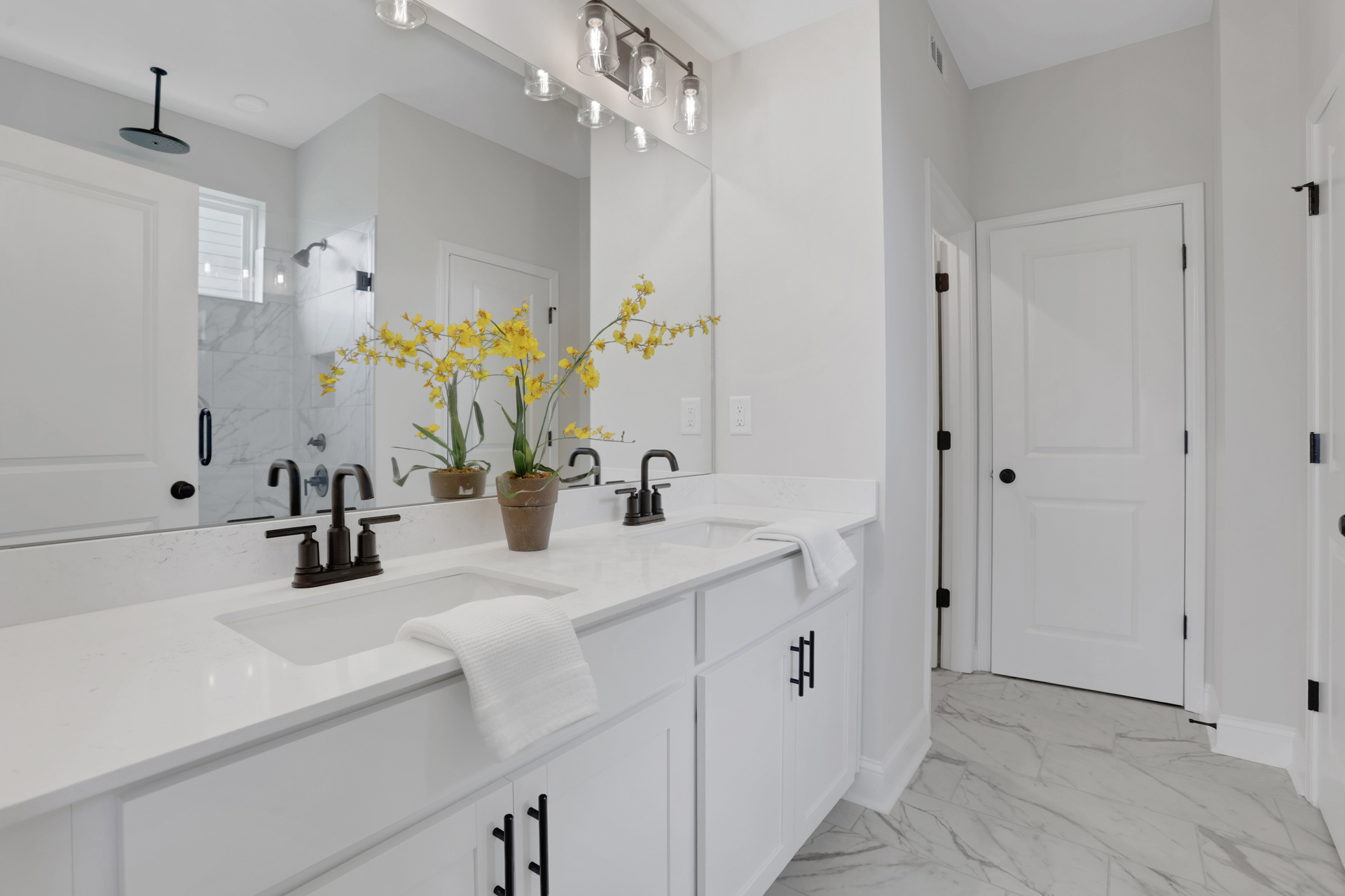 primary bathroom with white cabinets and tile flooring