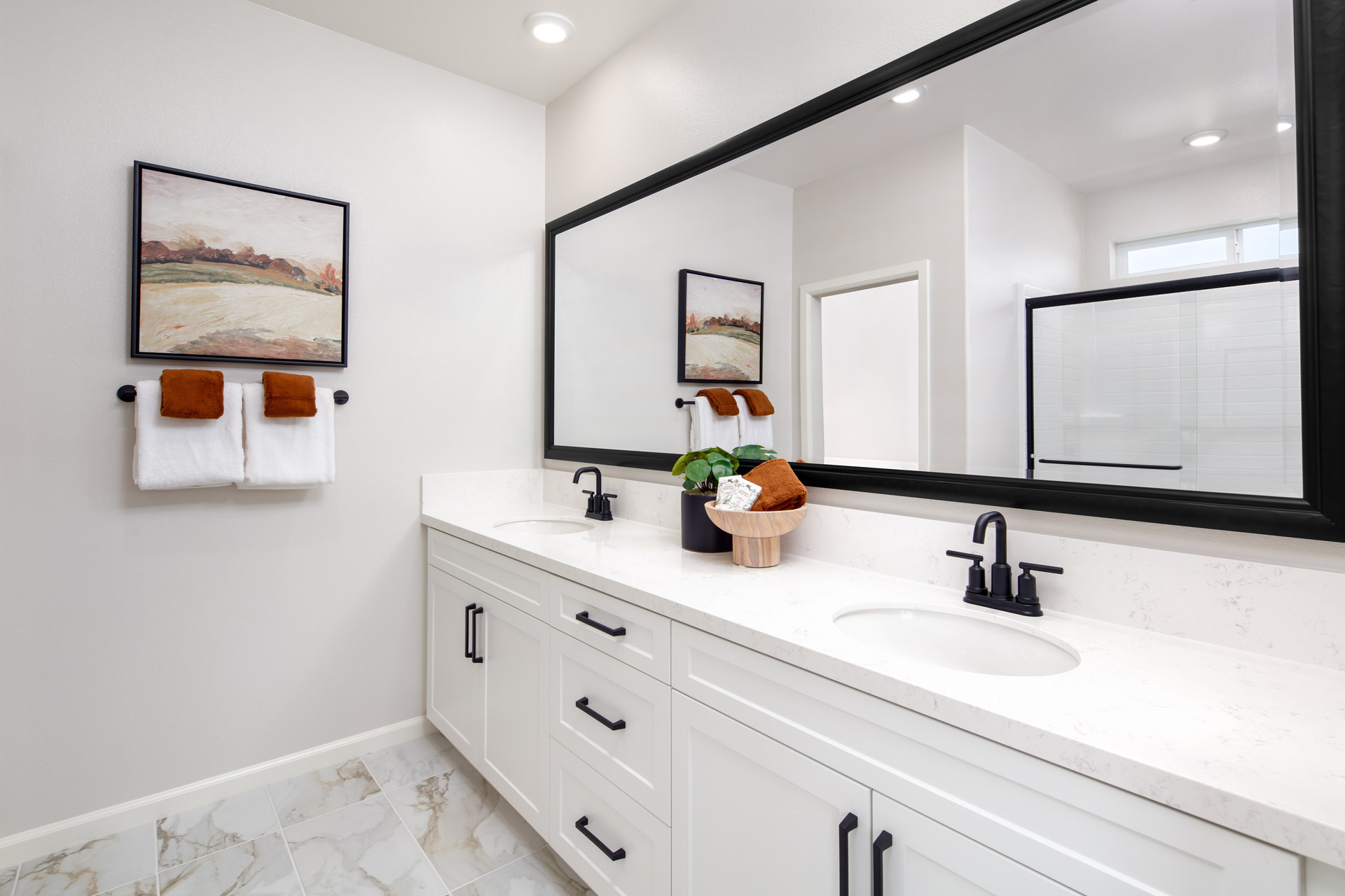primary bathroom with white countertops and cabinets
