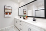 primary bathroom with white countertops and cabinets