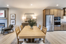 dining room with wood table between kitchen and great room