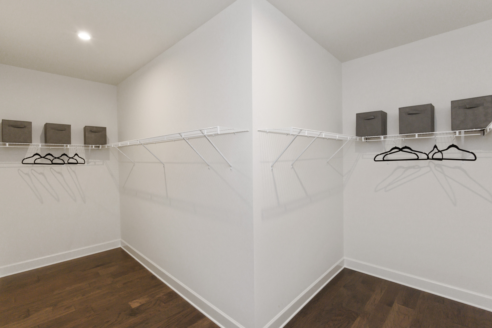 primary closet with divider and built in wire shelf