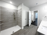 spacious primary bathroom with walk-in shower