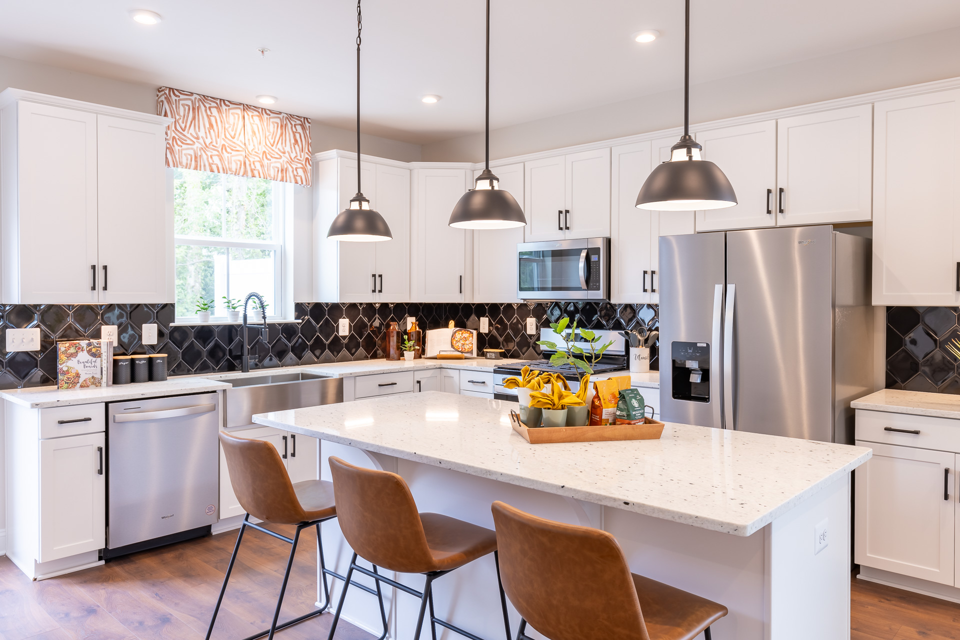 kitchen with white cabinets and a dark backsplash
