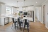 kitchen with white countertops, white cabinets, a large island, and stainless steel appliances