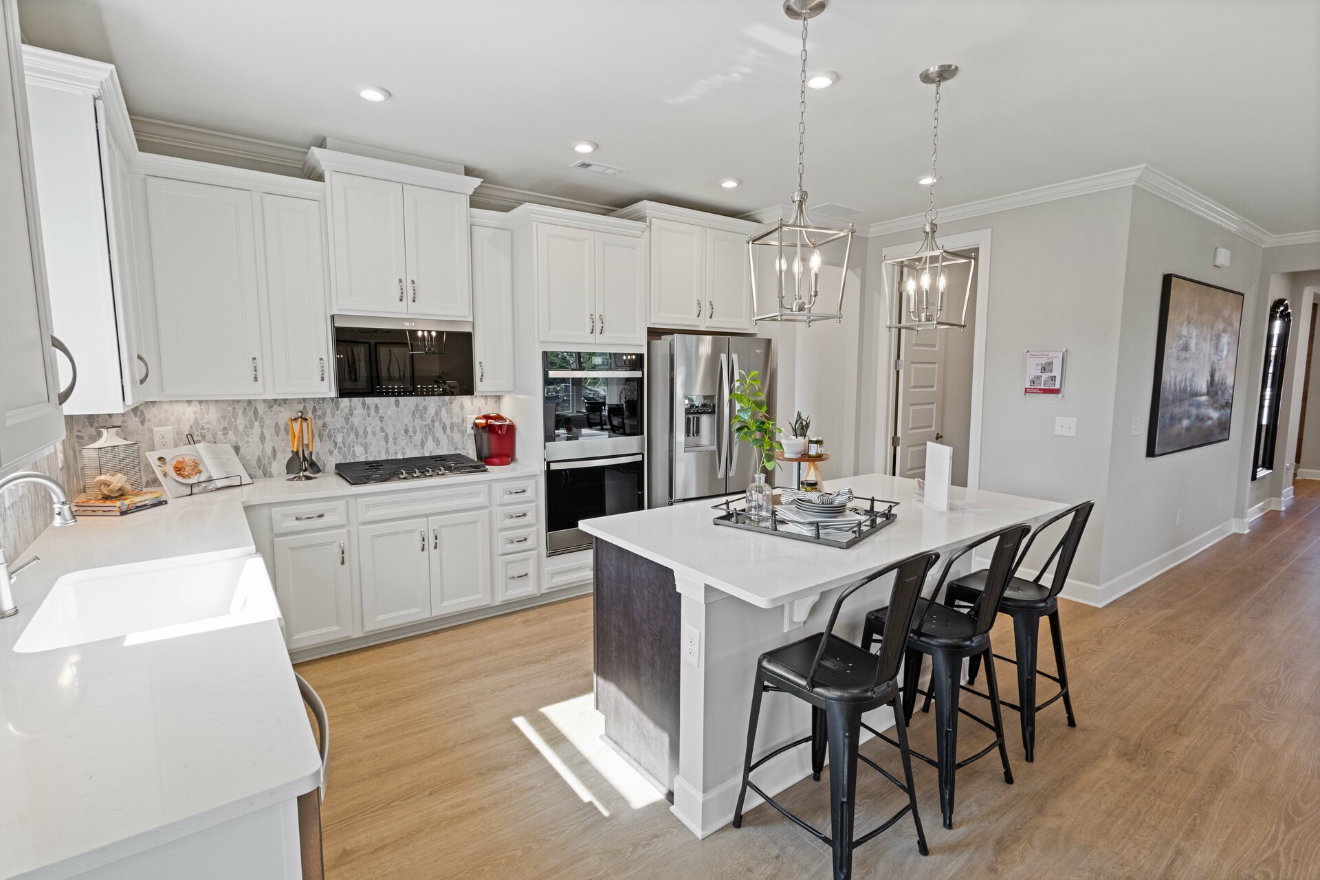 kitchen with white countertops, white cabinets, a large island, and stainless steel appliances
