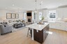 kitchen with white countertops, white cabinets, a large island, and stainless steel appliances