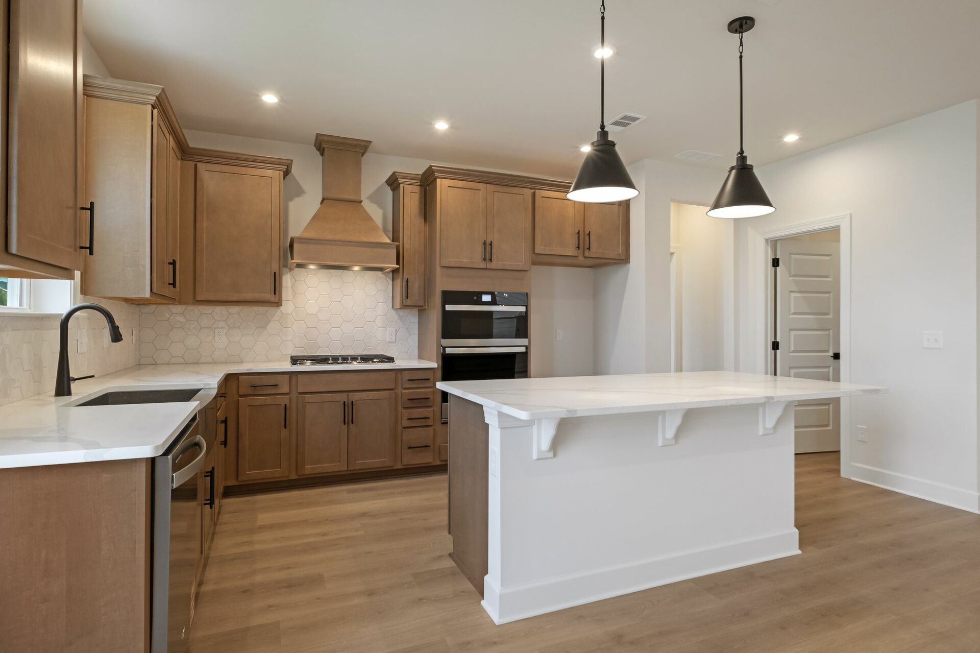 kitchen with wood cabinets, white countertops, and stainless steel appliances