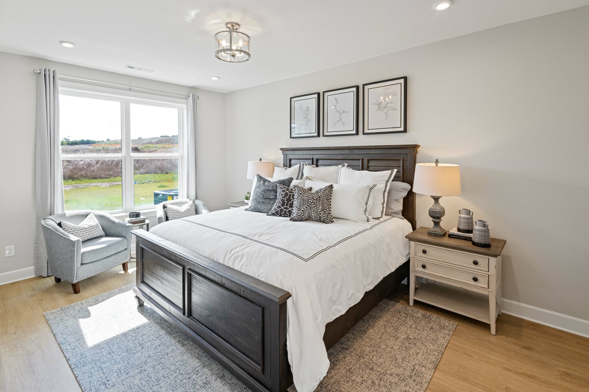 secondary bedroom with carpet flooring, bed, nightstands, and large windows