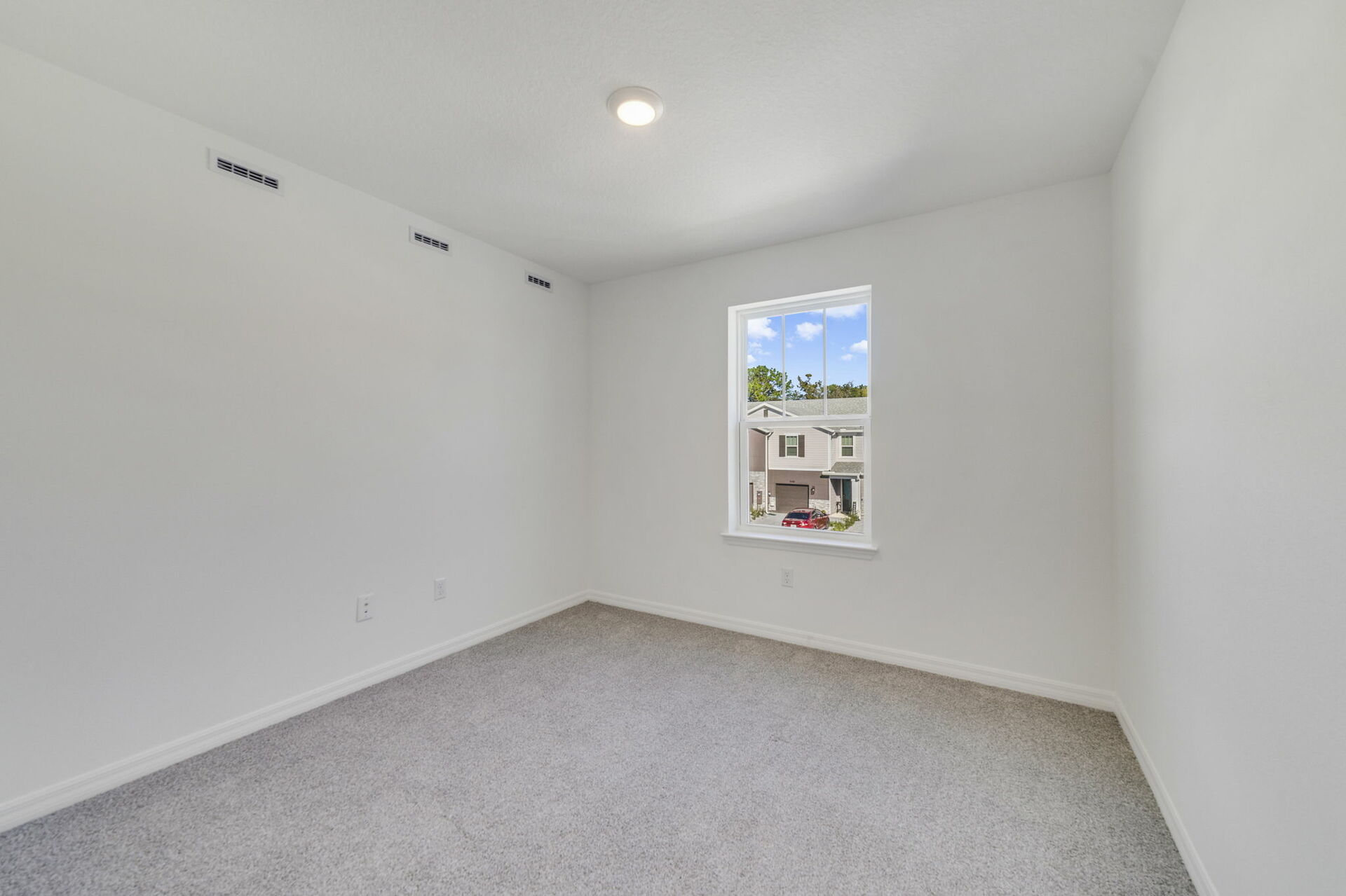 guest bedroom with closet, single window and carpet