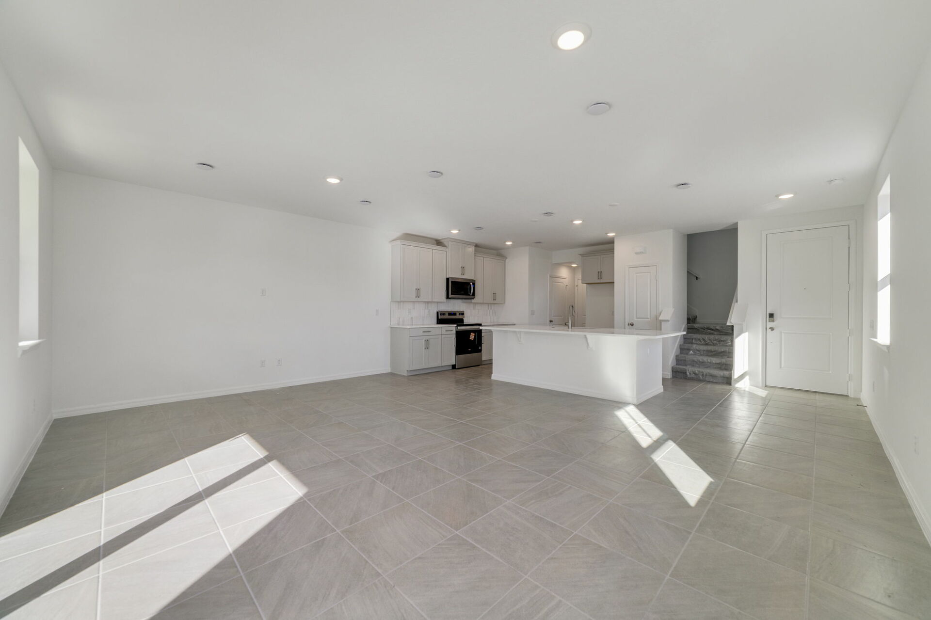 Great room with view of kitchen and patio 