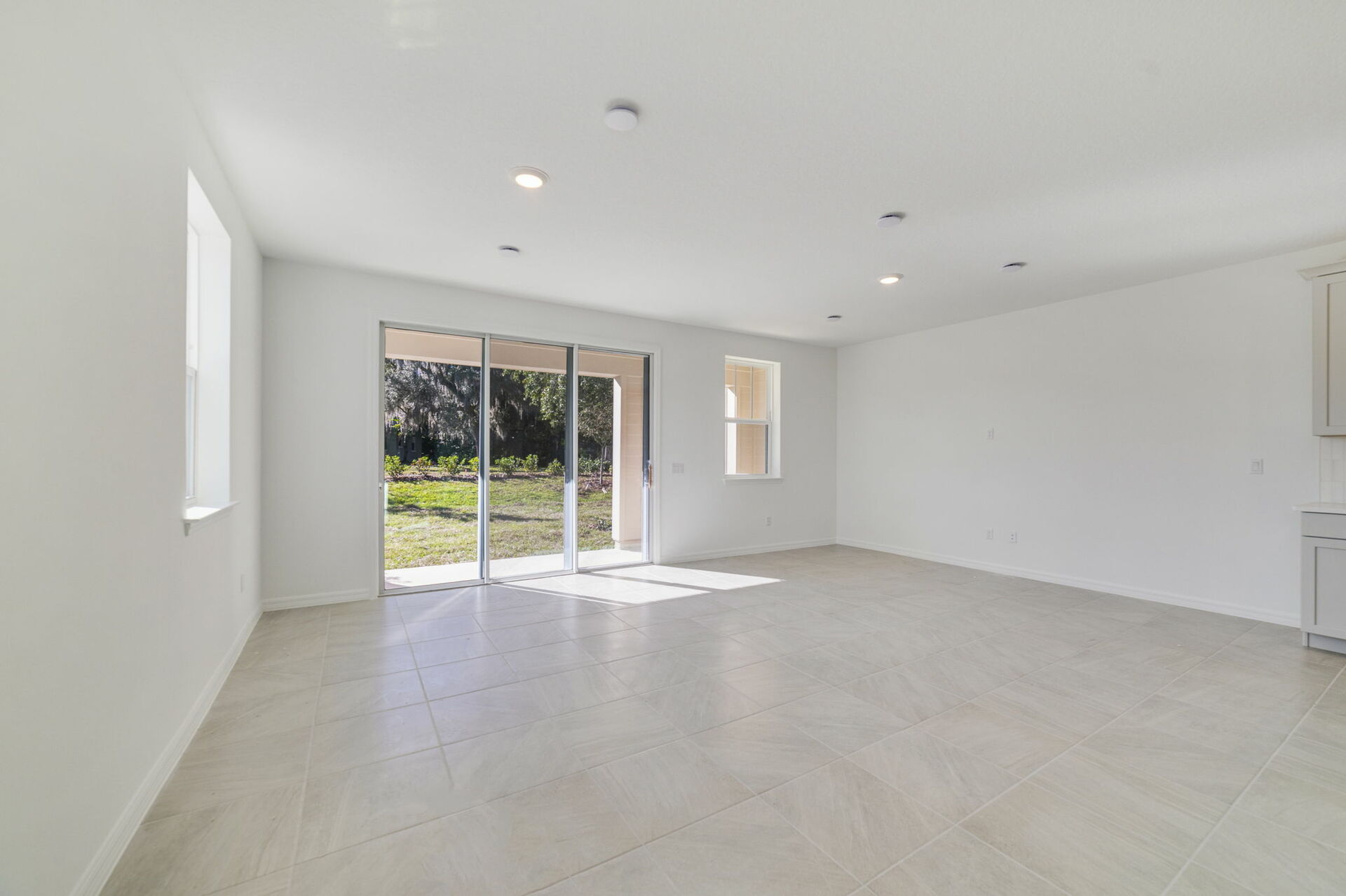 Great room with view of kitchen and patio 