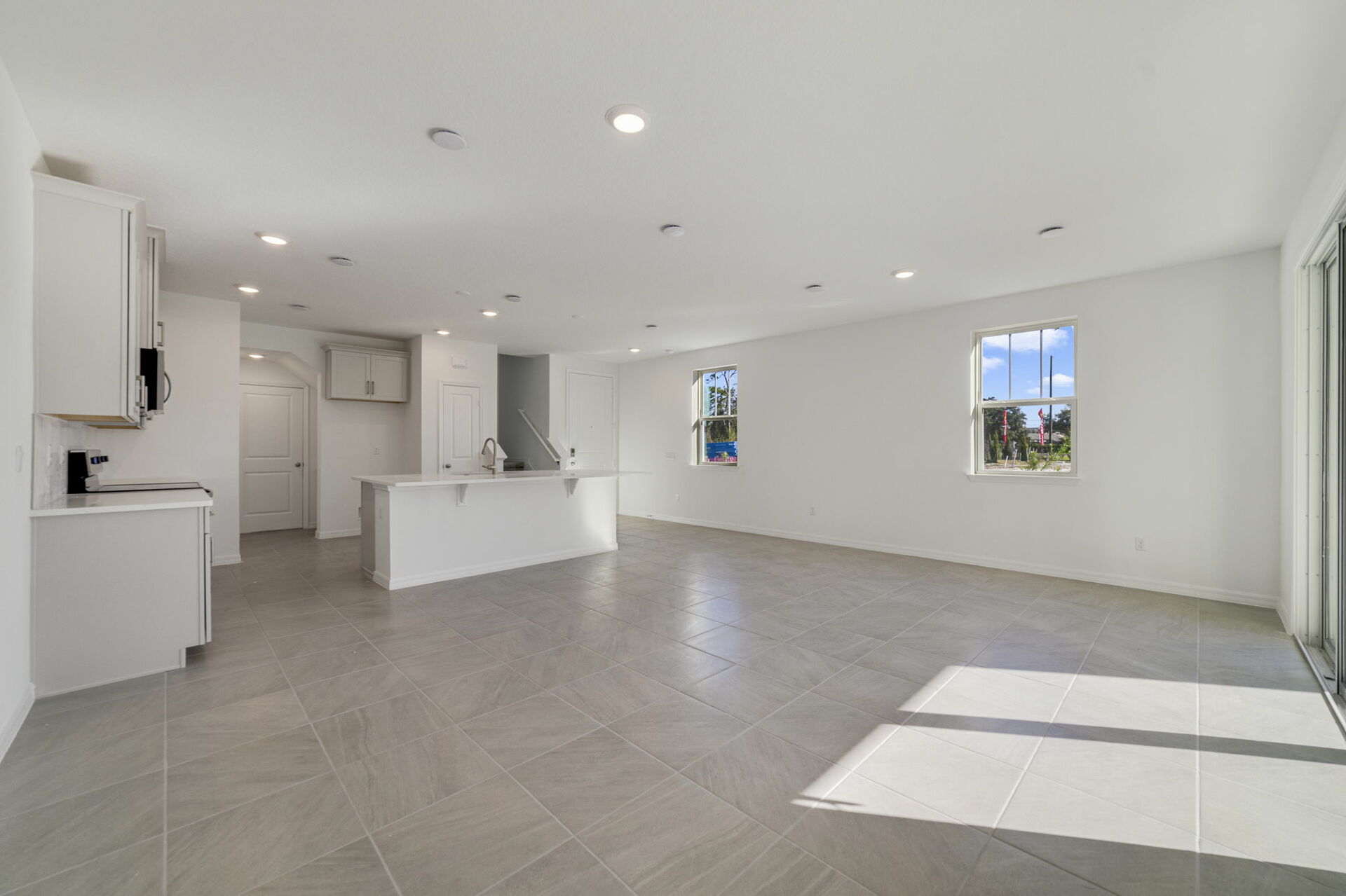 Great room with view of kitchen and patio 