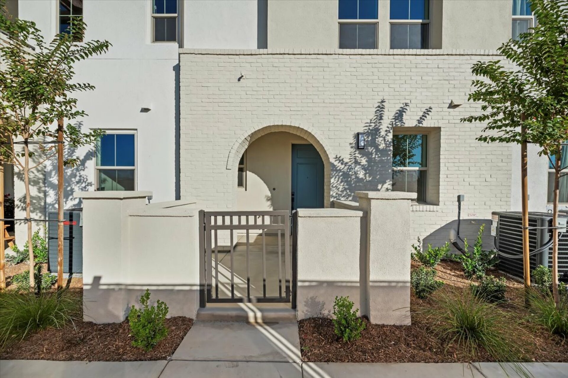 exterior with a brick archway and large front porch