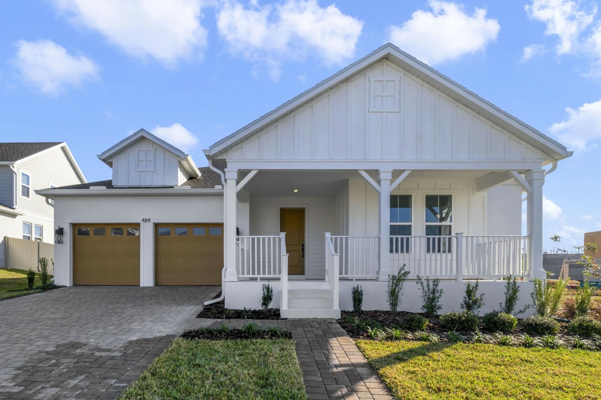Front exterior of home with two car garage and front door entrance