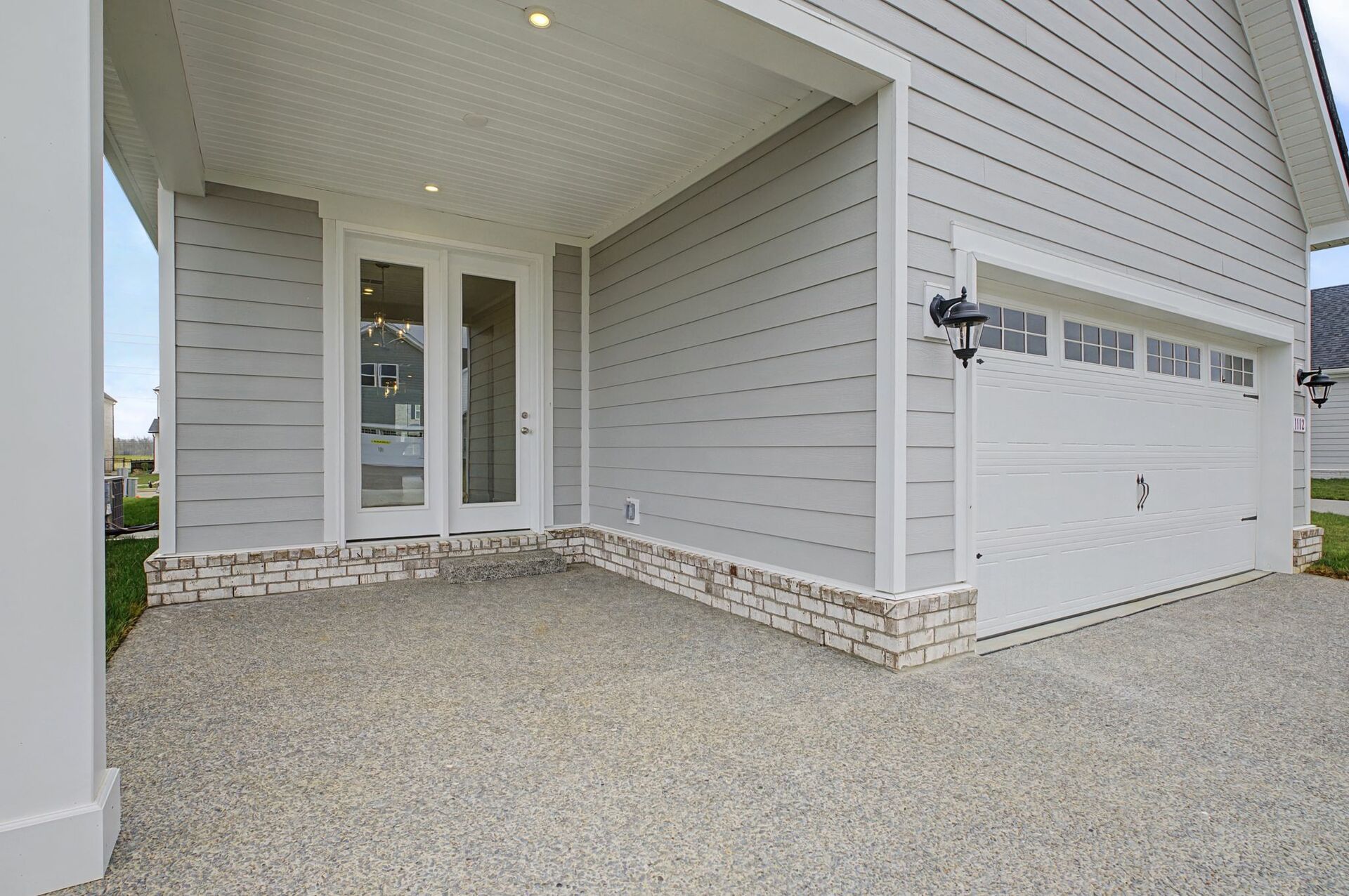 covered patio with white trim and glass doors