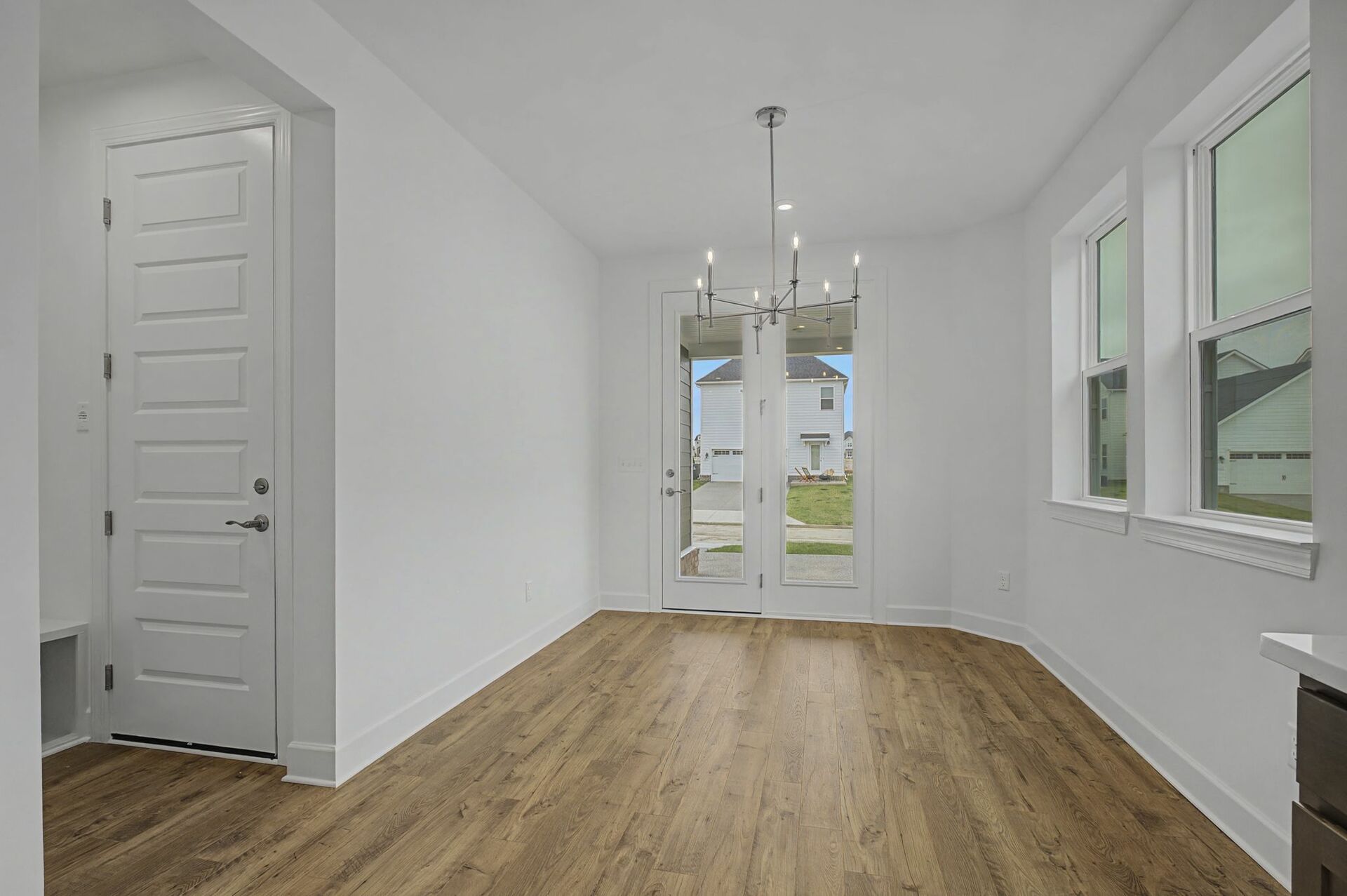 dining room with wood flooring, large windows, and glass doors to the outside