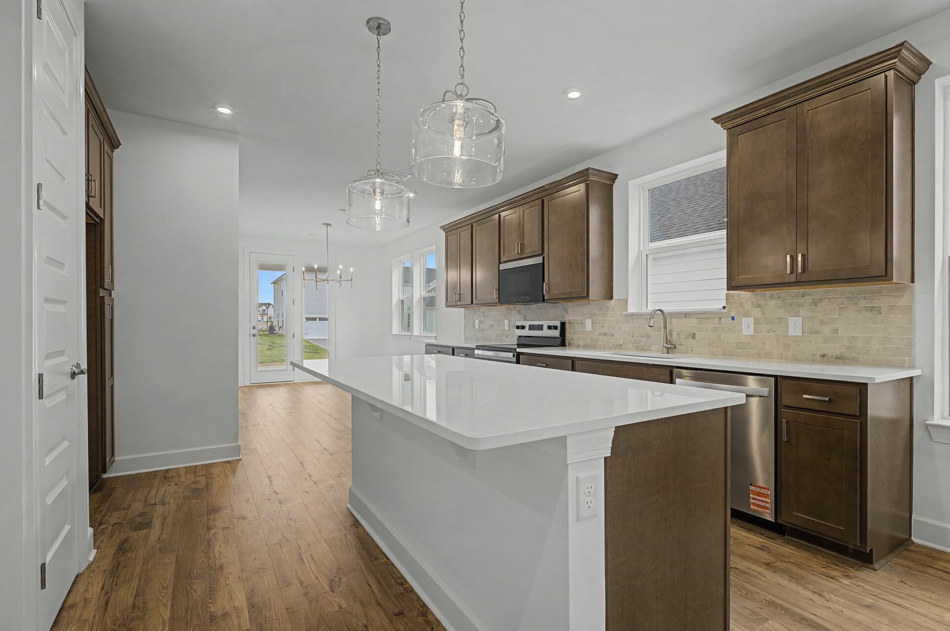 kitchen with wood flooring, wood cabinets, and white countertops