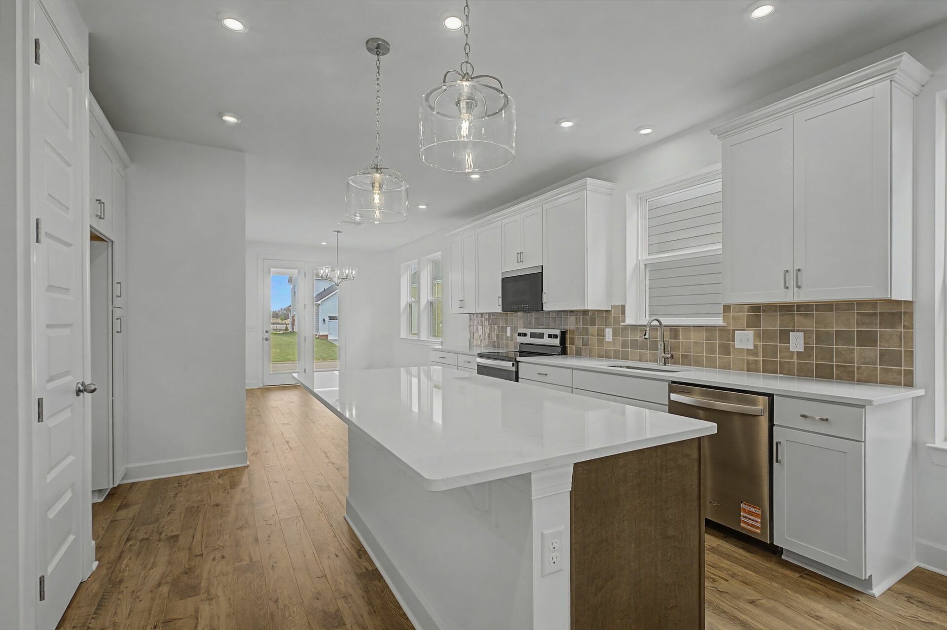 kitchen with wood flooring, white counter tops, and stainless steel appliances