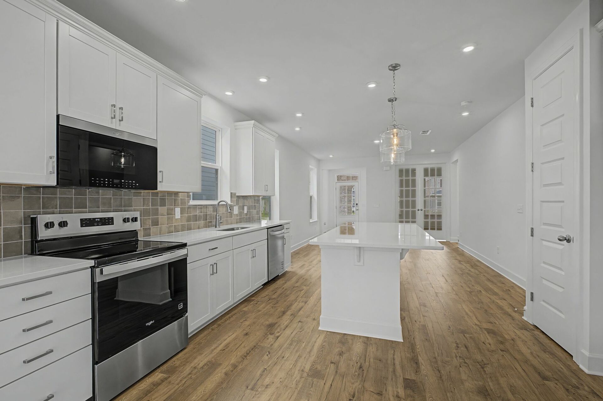 kitchen with wood flooring, white counter tops, and stainless steel appliances