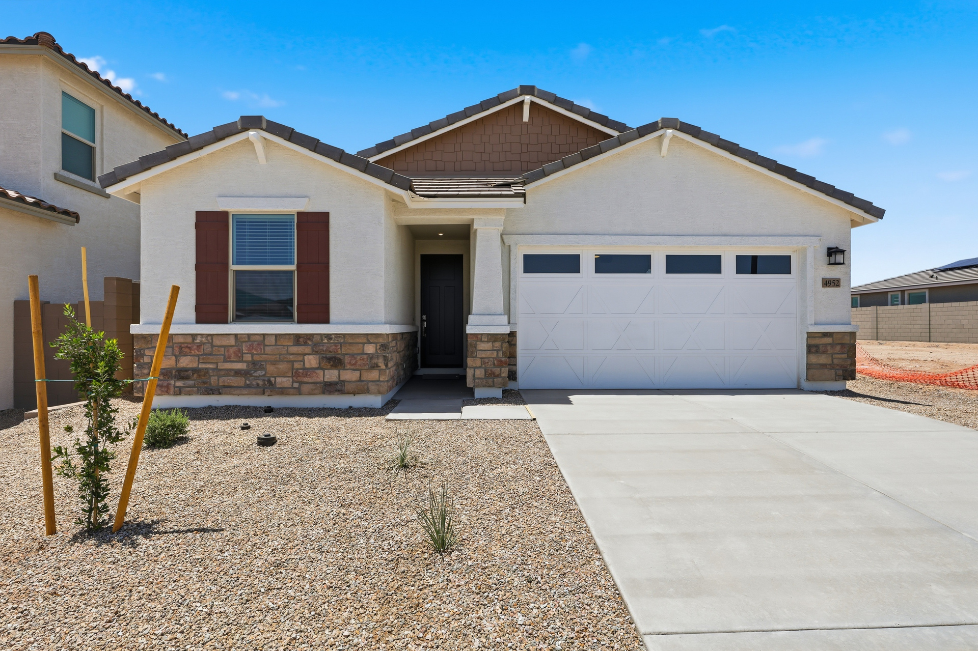 single-story single-family home with a concrete driveway and desert landscaping