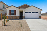 single-story single-family home with a concrete driveway and desert landscaping