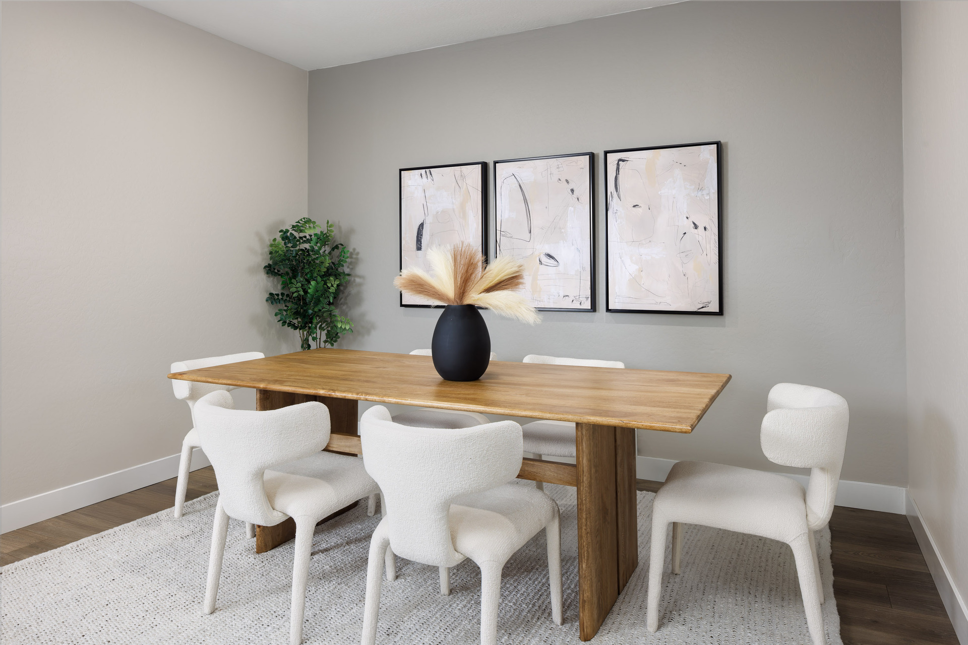 spacious dining room with wooden dining table and white chairs