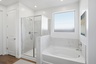 spacious bathroom with soaking tub and walk-in shower