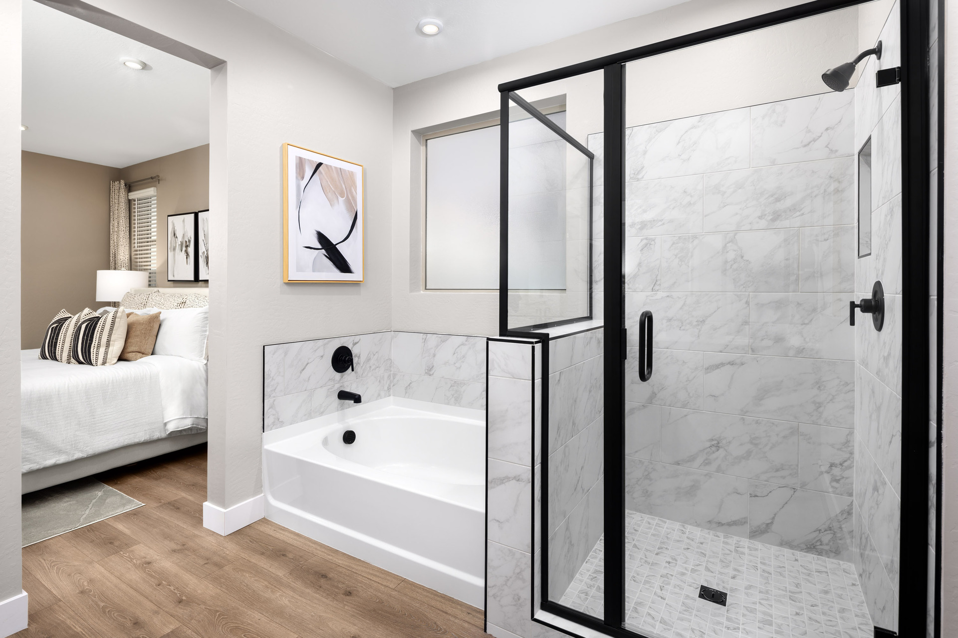 bathroom with wood-like flooring, walk-in shower, and soaking tub