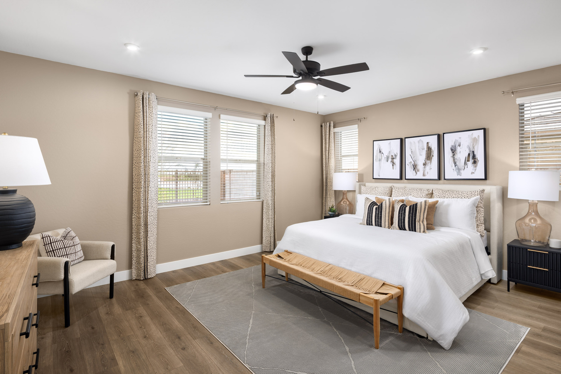 spacious bedroom with a large white bed and a wooden bench