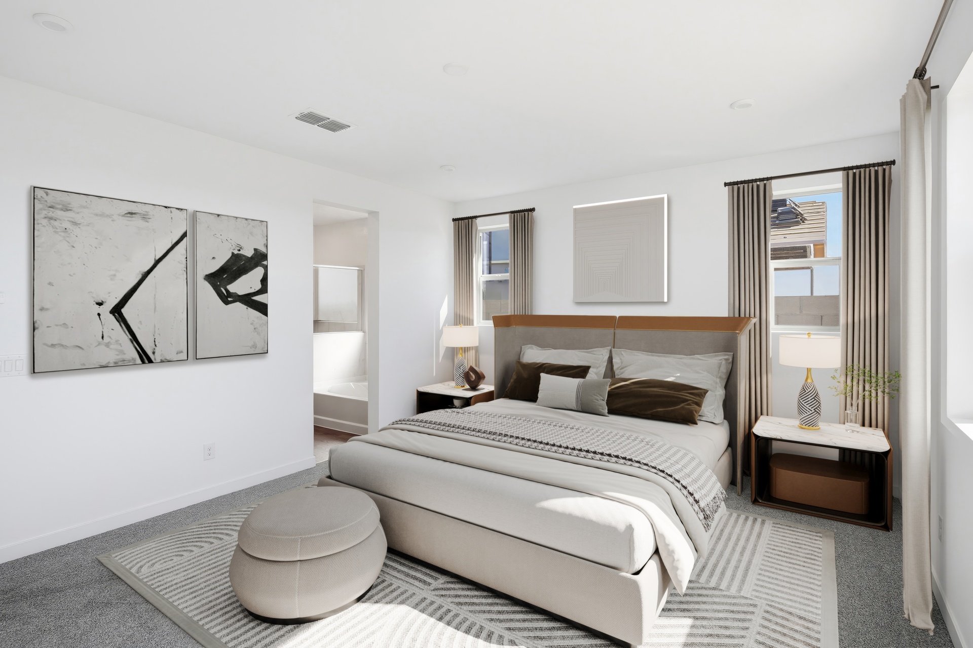 spacious great room with a large bed with neutral-colored sheets, light beige rug and brown accents