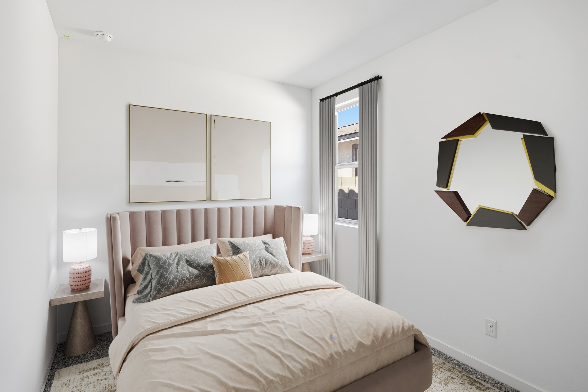 bedroom with a large bed, silver accent pillows, and artwork on the wall