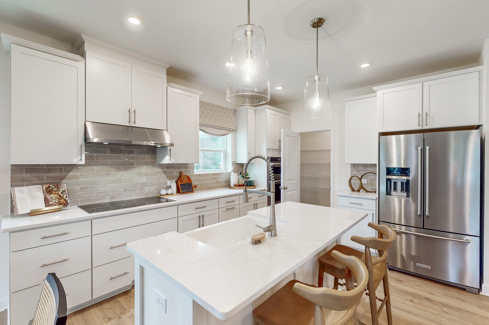 kitchen with white cabinets and tile backsplash 