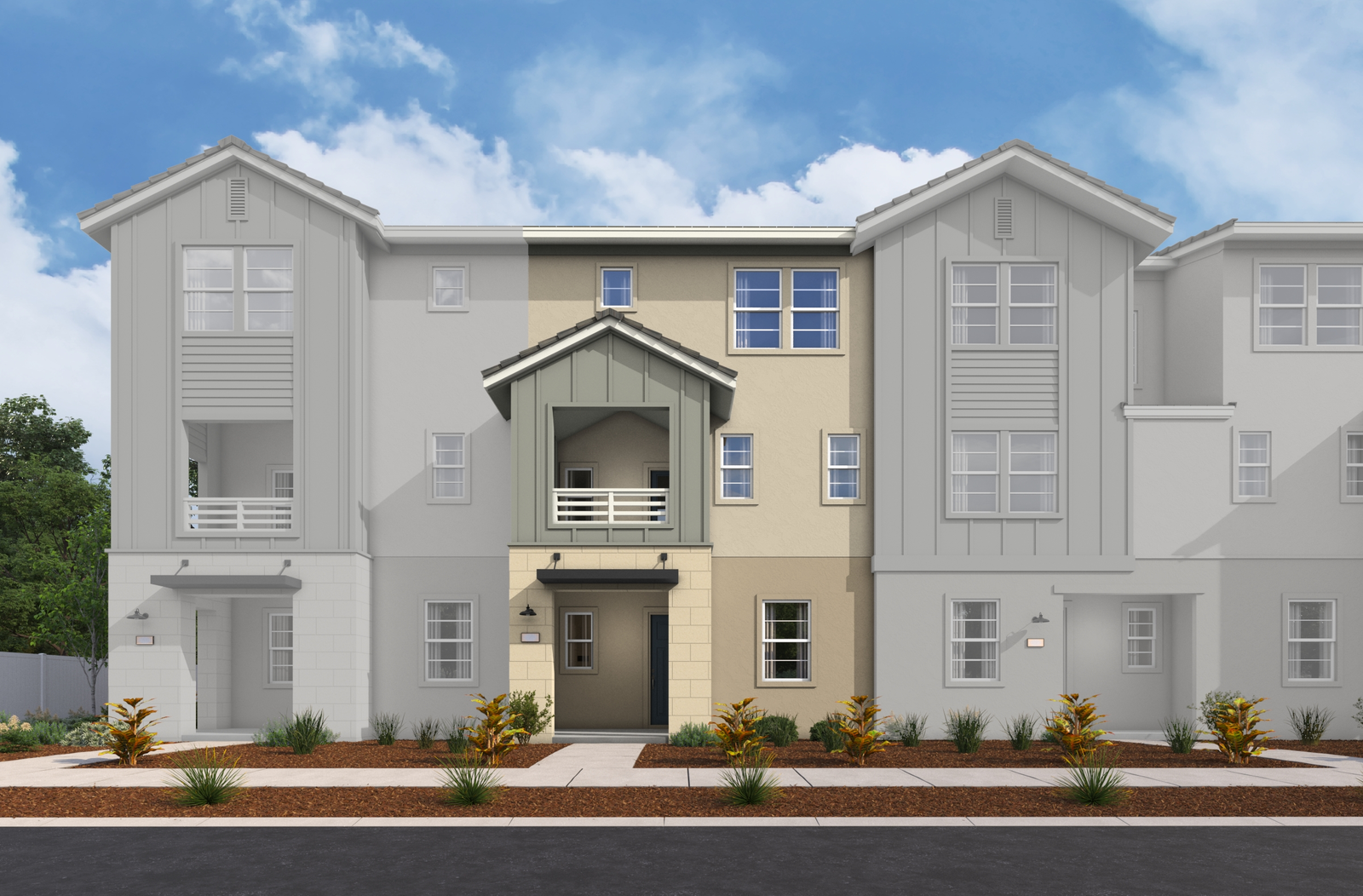 exterior of three-story townhome with desert landscaping and large windows