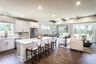 kitchen, great room, and dining room with hard surface flooring and decor