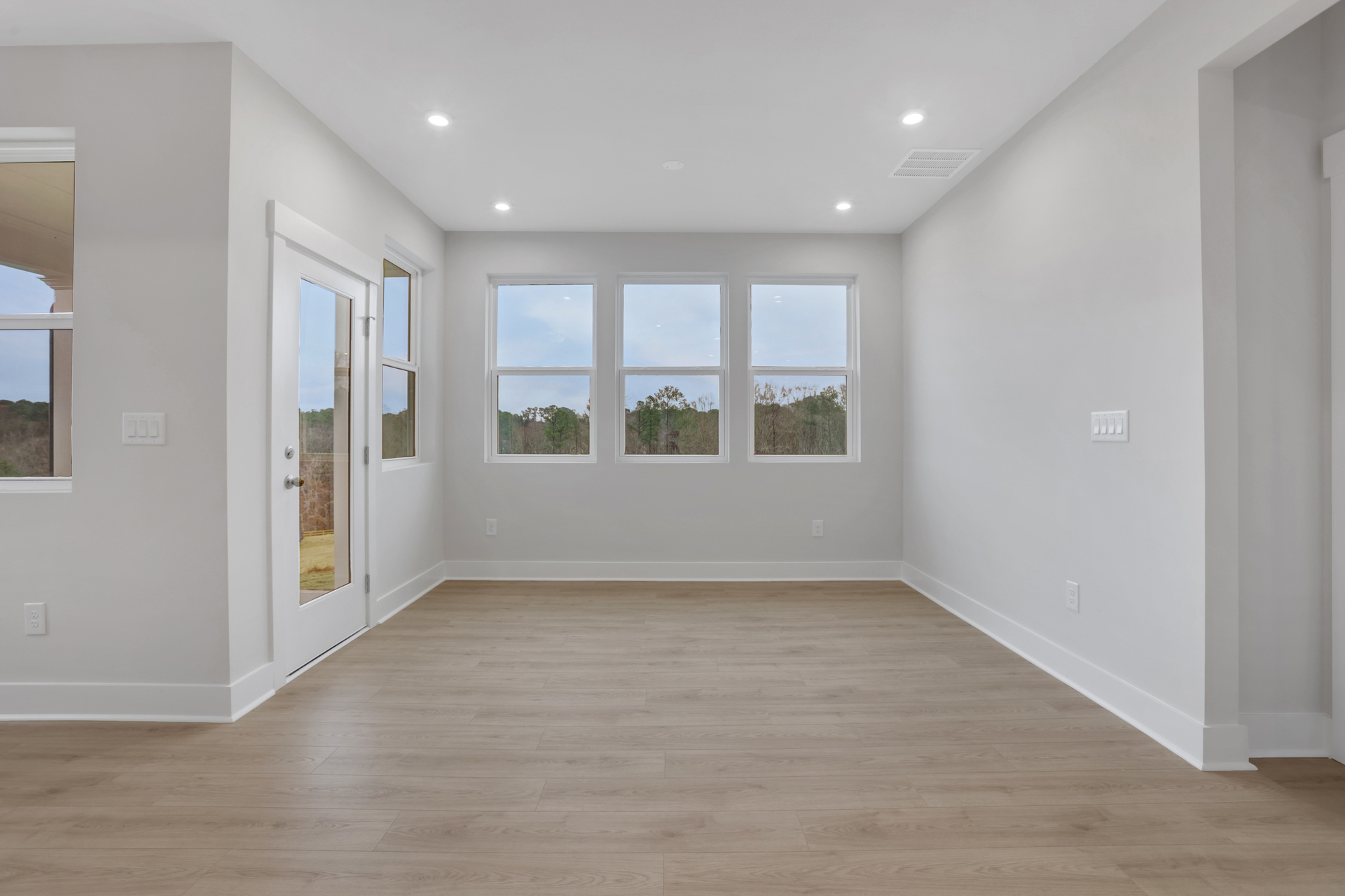 dining room with hard-surface flooring and windows